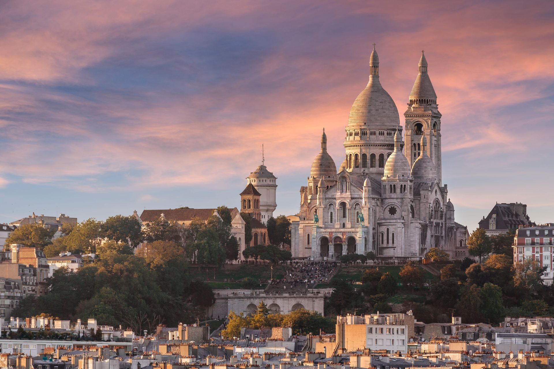 The Sacré-Cœur basilica and Montmartre rooftops at sunset